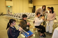 吹奏楽の楽器演奏を体験する参加者の写真